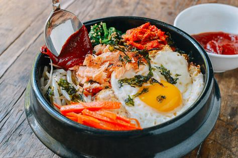 Bước 4: Trình bày và thưởng thức
Cho cơm nóng vào tô.
Xếp lần lượt các nguyên liệu xào, rau củ, thịt bò và trứng lên mặt cơm.
Rưới nước sốt lên, trộn đều trước khi ăn.