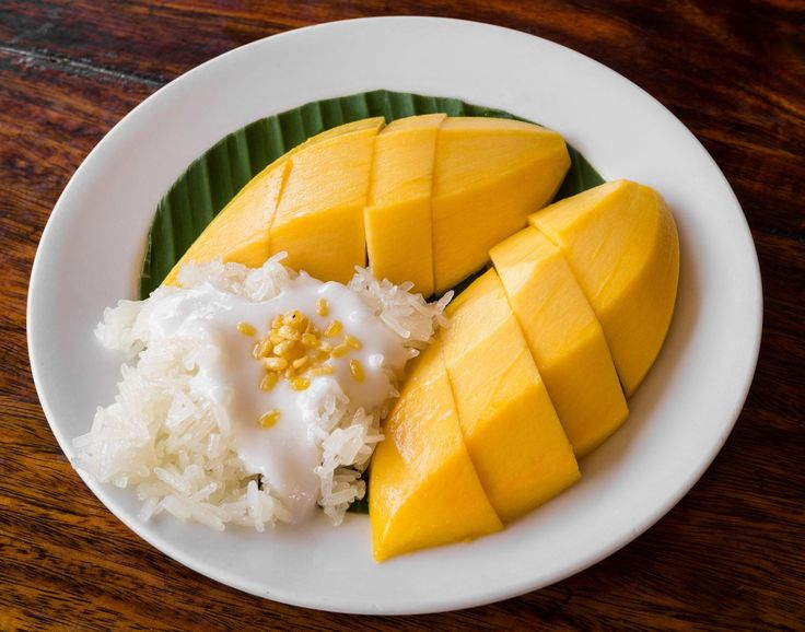 Xôi xoài Thái Lan (Khao Niew Mamuang) là món tráng miệng nổi tiếng của xứ sở chùa vàng, kết hợp giữa gạo nếp dẻo thơm, nước cốt dừa béo ngậy và xoài chín ngọt lịm. Nếu các bạn đang tìm công thức cách làm xôi xoài Thái Lan thì hãy cùng theo chân yêu bếp núc tìm hiểu dưới bài viết dưới sau đây nhé.
Món ăn này không chỉ hấp dẫn về hương vị mà còn về màu sắc bắt mắt, khiến ai cũng muốn thưởng thức ngay từ cái nhìn đầu tiên. Nên nó rất thích hợp làm món ăn dành những bữa tiệc gia đình thưởng thức hoặc làm món ăn vặt vào cuối tuần cho cả người lớn và những em bé đã ăn dặm. Cách làm món xôi xoài thì không quá cầu kì, phức tạp mọi người ai cũng có thể thử và làm được thành công chỉ cần theo một số mẹo và bước làm của mình.